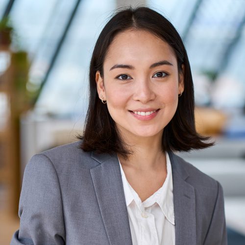 young smiling asian business woman standing in off 2023 11 27 04 59 17 utc